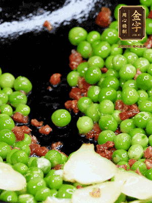 鍋內(nèi)少許油，下火腿煸香，再下甜豆米、百合翻炒，少許鹽、一點水煮到收干